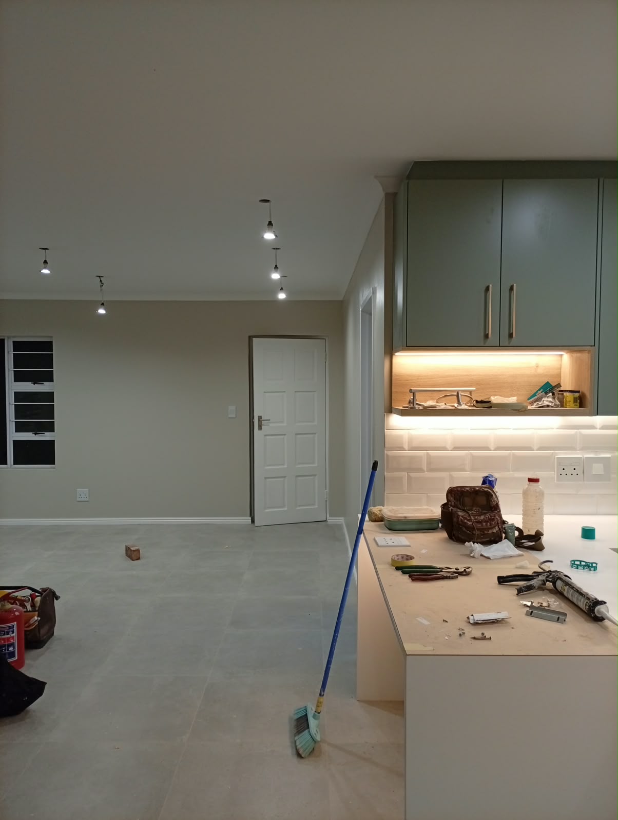 Herringbone laminate flooring going down in a room with a sea view through the balcony door