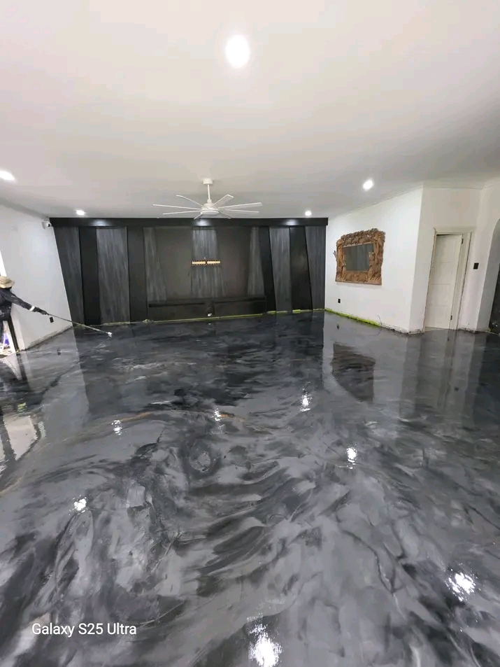 The same finished metallic epoxy floor from another angle, wide open-plan room